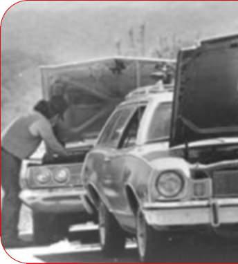 Left half of a car. There's a guy working on it.